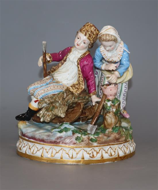 A Meissen porcelain group emblematic of Winter, modelled as a boy seated on a sledge and a girl warming her hands at a brazier, height